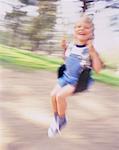 Blurred View of Boy on Swing