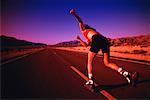 Back View of Woman In-Line Skating on Road at Dusk