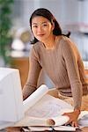 Portrait of Businesswoman with Blueprints at Desk