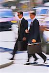 Blurred View of Businessmen Crossing Street