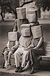 Portrait of Family with Paper Bags over Heads in Park