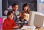 Portrait of Students at Computer In Classroom