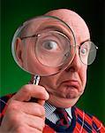 Man Looking Through Magnifying Glass