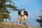 Couple Hiking, Reading Map Temagami, Ontario, Canada