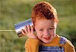 Child Using Tin Can Telephone Outdoors