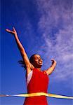 Female Runner Crossing Finish Line