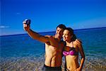 Couple in Swimwear, Taking Self Portrait on Beach