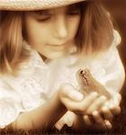 Girl Holding Frog in Palm of Hand