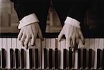 Close-Up of Hands Playing Piano