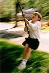 Blurred View of Boy on Rope Swing