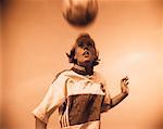 Female Soccer Player Bouncing Ball on Head