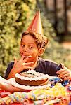 Boy Eating Cake Outdoors