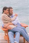 Couple Sitting in Chair on Dock