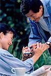 Mature Man Giving Ring to Mature Woman Outdoors