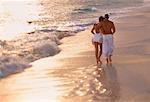 Vue arrière du Couple d'âge mûr marchant sur la plage