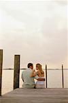 Back View of Couple Sitting on Dock