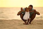 Father Helping Daughter to Walk On Beach