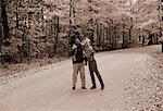 Family Walking on Country Road In Autumn