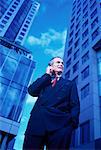 Mature Businessman Using Cell Phone Outdoors