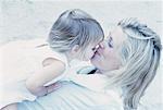 Mother Kissing Daughter Outdoors