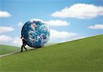 Businessman Rolling Globe Up Hill