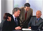 Business People Using Laptop Computer in Meeting