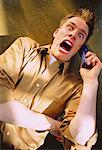 Frightened Man Using Cordless Telephone