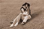 Portrait of Family Sitting in Field