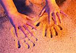 Close-Up of Hands and Handprints In Sand