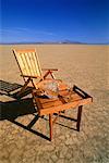 Deck Chair, Table and Glass of Water in Desert Nevada, USA