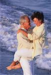 Mature Couple Embracing on Beach