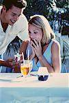 Man Giving Gift to Woman at Outdoor Cafe