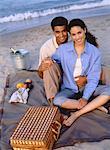 Portrait of Couple Having Picnic On Beach