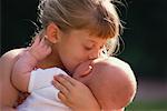 Girl Kissing Baby