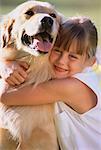 Portrait of Girl Hugging Dog Outdoors