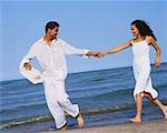 Couple Walking on Beach, Holding Hands