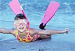 Girl in Swimwear, Lying on Beach Wearing Snorkel and Flippers