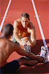 Men Stretching on Outdoor Track