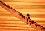 Woman Running Up Stadium Stairs