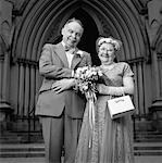 Portrait of Mature Couple in Formal Wear Standing in Front of Church