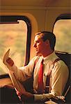 Businessman Reading Newspaper While Travelling
