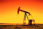 Oil Pump Jack in Motion at Sunset Alberta, Canada