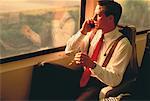 Businessman Using Cell Phone on Train