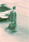 Blurred View of Businessman Walking on Street