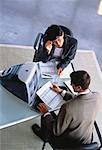 Overhead View of Businessman and Businesswoman in Meeting