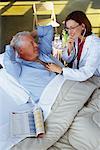 Doctor Listening to Mature Man's Heart with Stethoscope