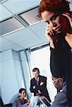 Businesswoman Using Telephone During Meeting
