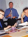 Businessman Giving Presentation In Front of White Board