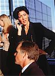 Businesswoman Using Cell Phone in Meeting