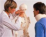 Female Physiotherapist and Male Patient Looking at Skeleton